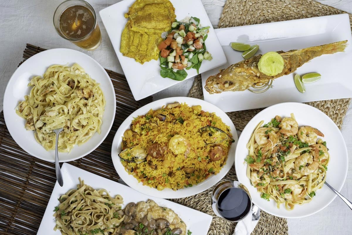 Colombian specialties — paella, grilled fish, and seafood pastas